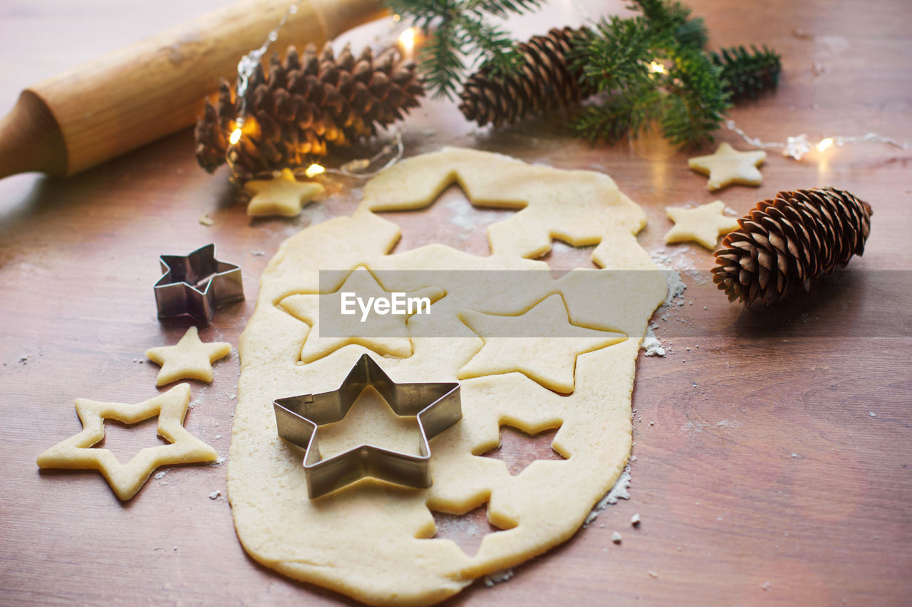 Making christmas cookies on a wooden table with various accessories,preparing for christmas