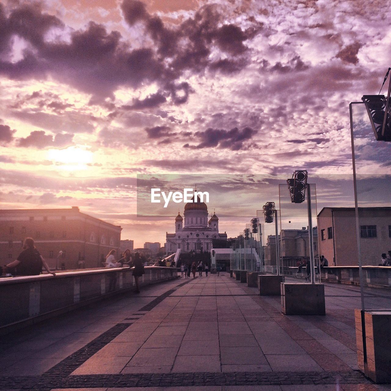 View of buildings against cloudy sky at sunset