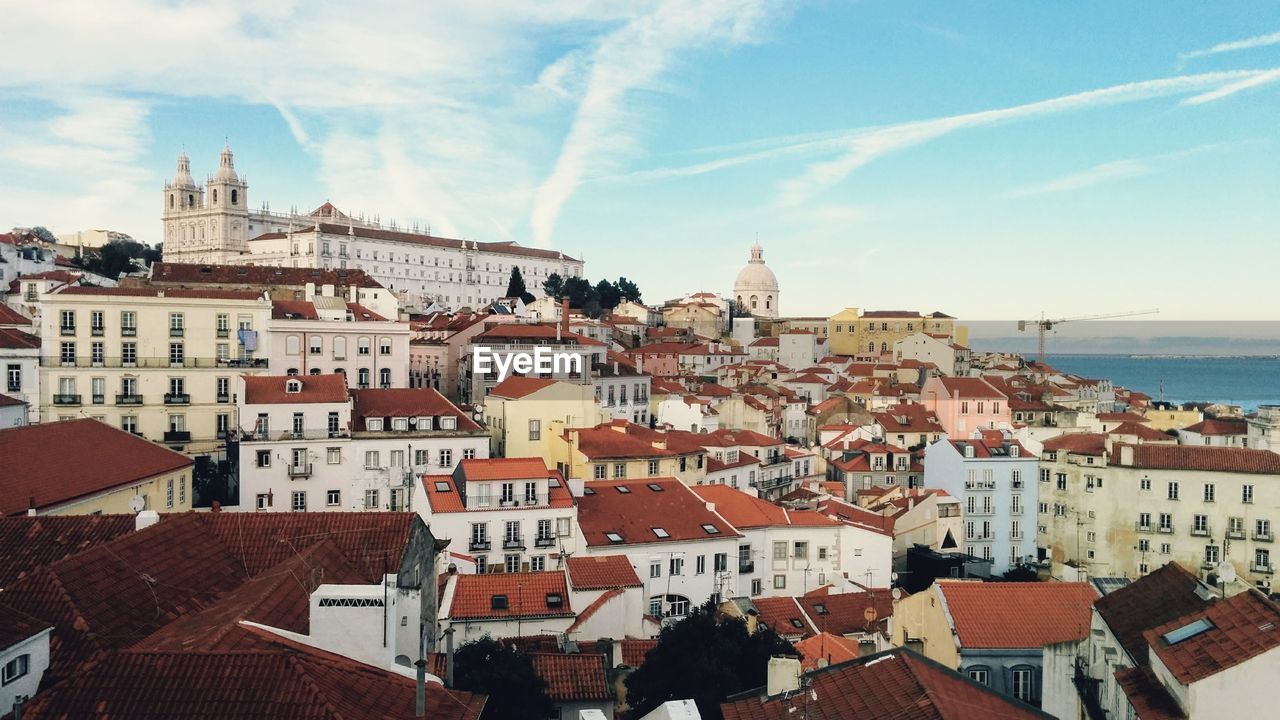 High angle view of houses in town against sky