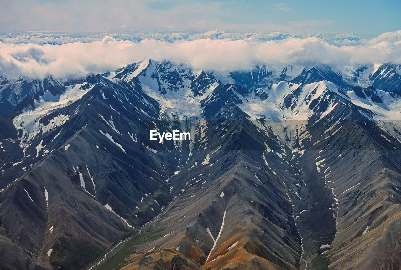 Aerial view of alpine glaciers cut in remote mountains in denali national park in alaska