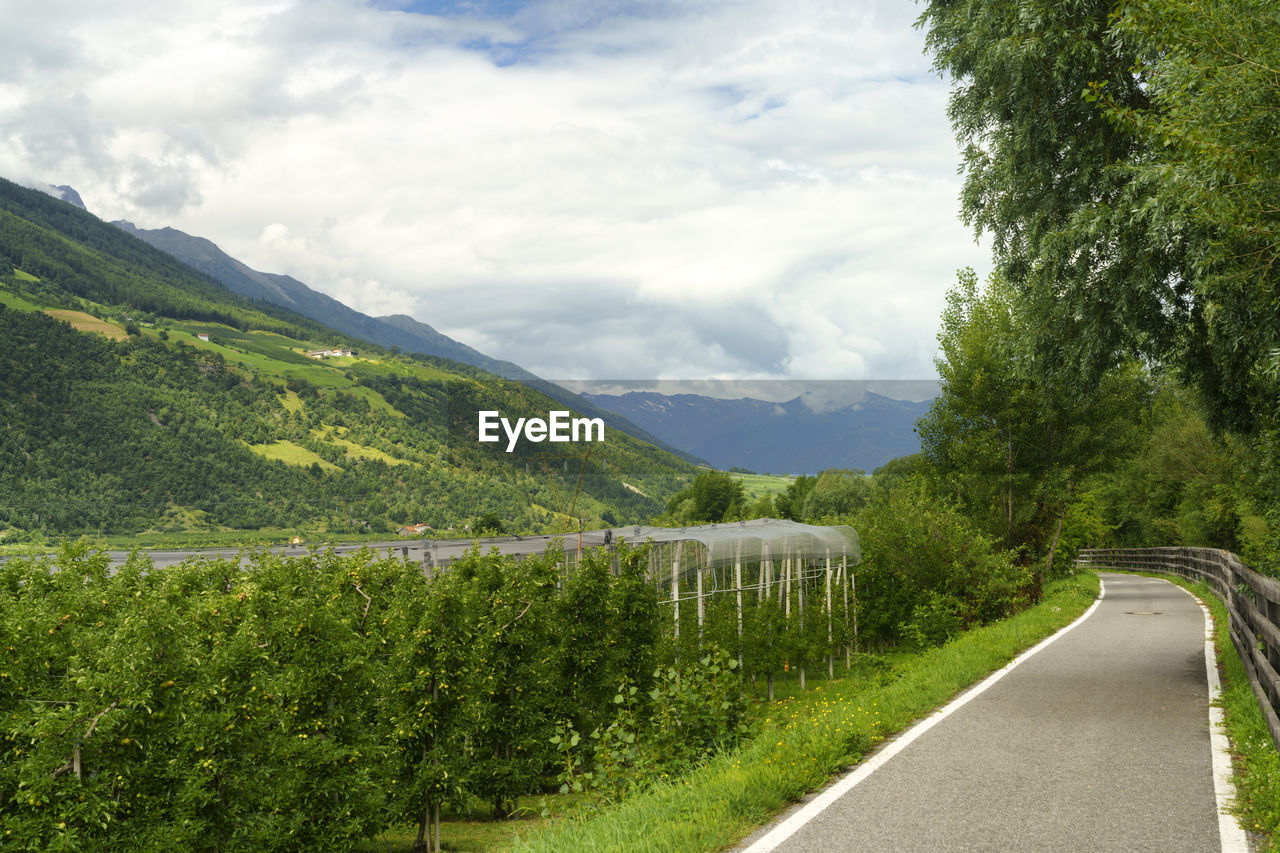 EMPTY ROAD ALONG LANDSCAPE AND MOUNTAINS AGAINST SKY