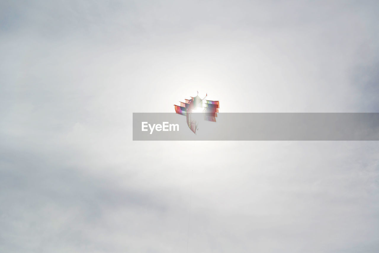 Low angle view of kite flying against sky