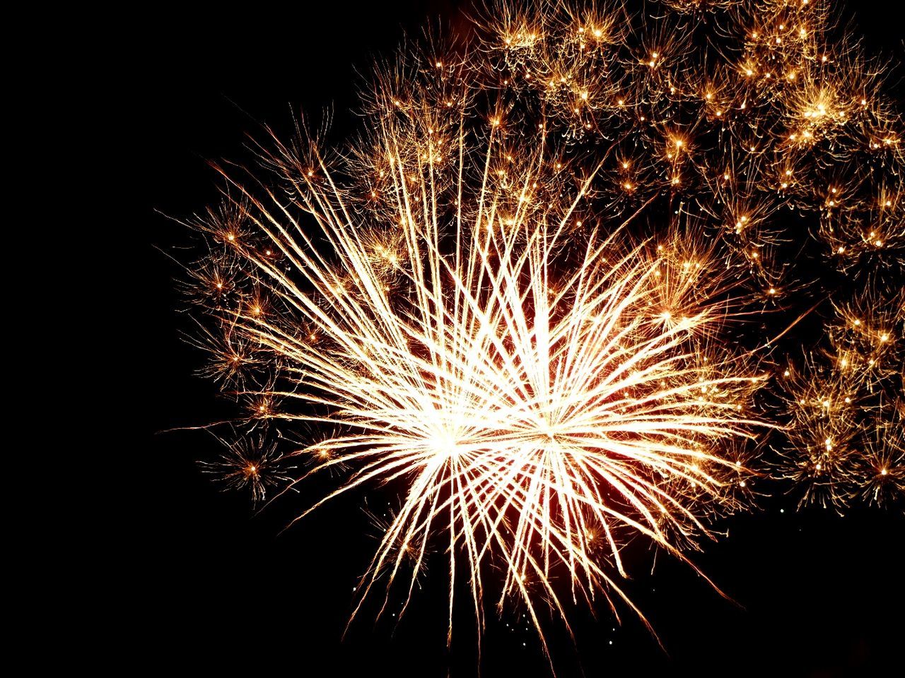 LOW ANGLE VIEW OF FIREWORKS DISPLAY