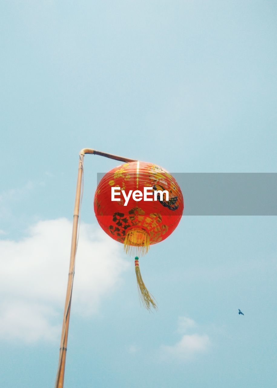 Low angle view of lantern against sky