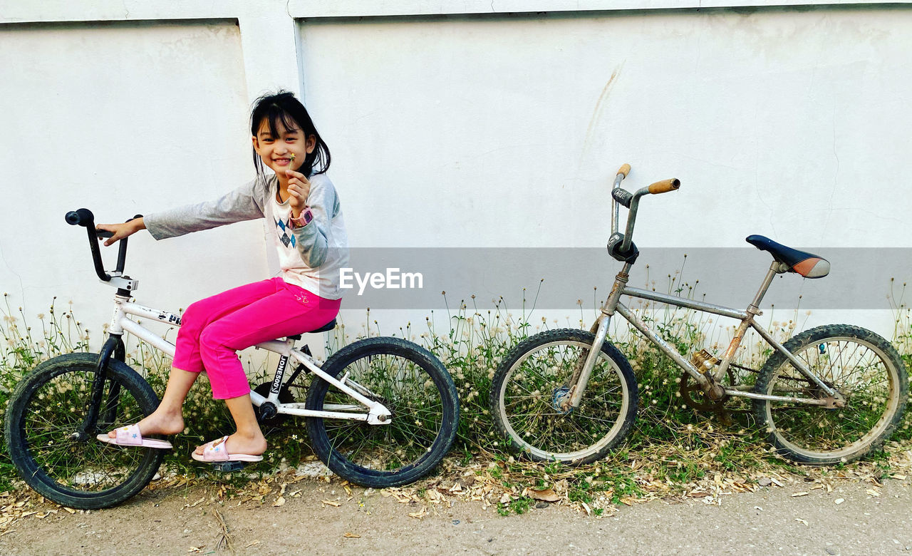 Portrait of young woman riding bicycle