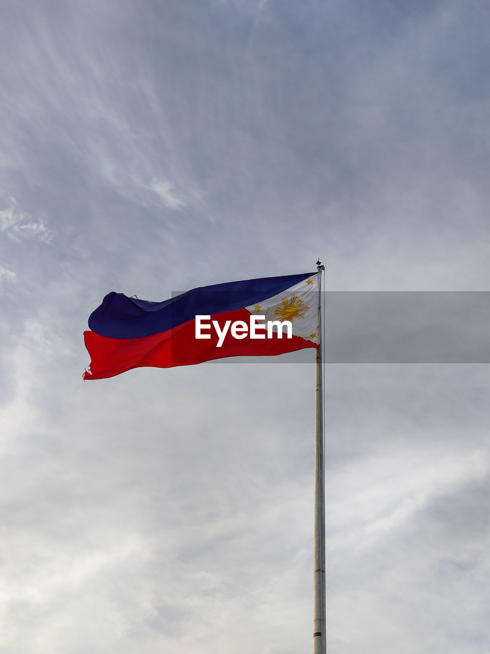 flag, patriotism, wind, sky, environment, cloud, red, blue, nature, low angle view, pole, no people, day, outdoors, symbol, pride