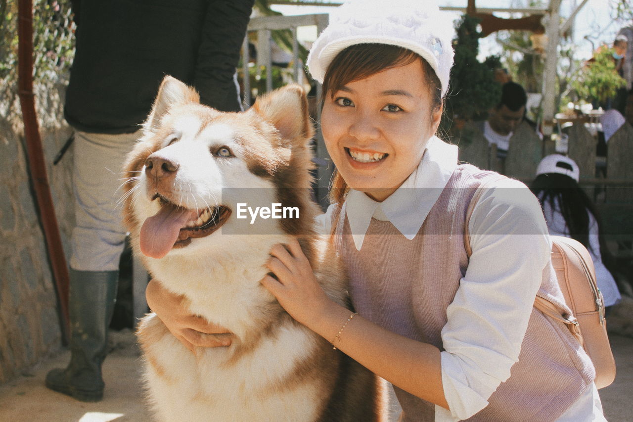 Portrait of smiling woman with dog