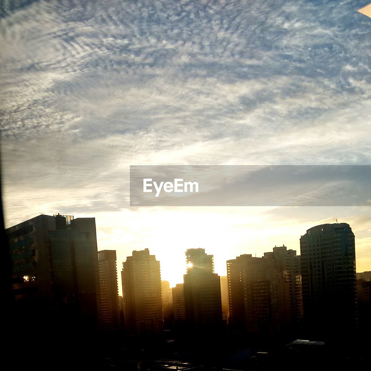 SKYSCRAPERS IN CITY AT DUSK