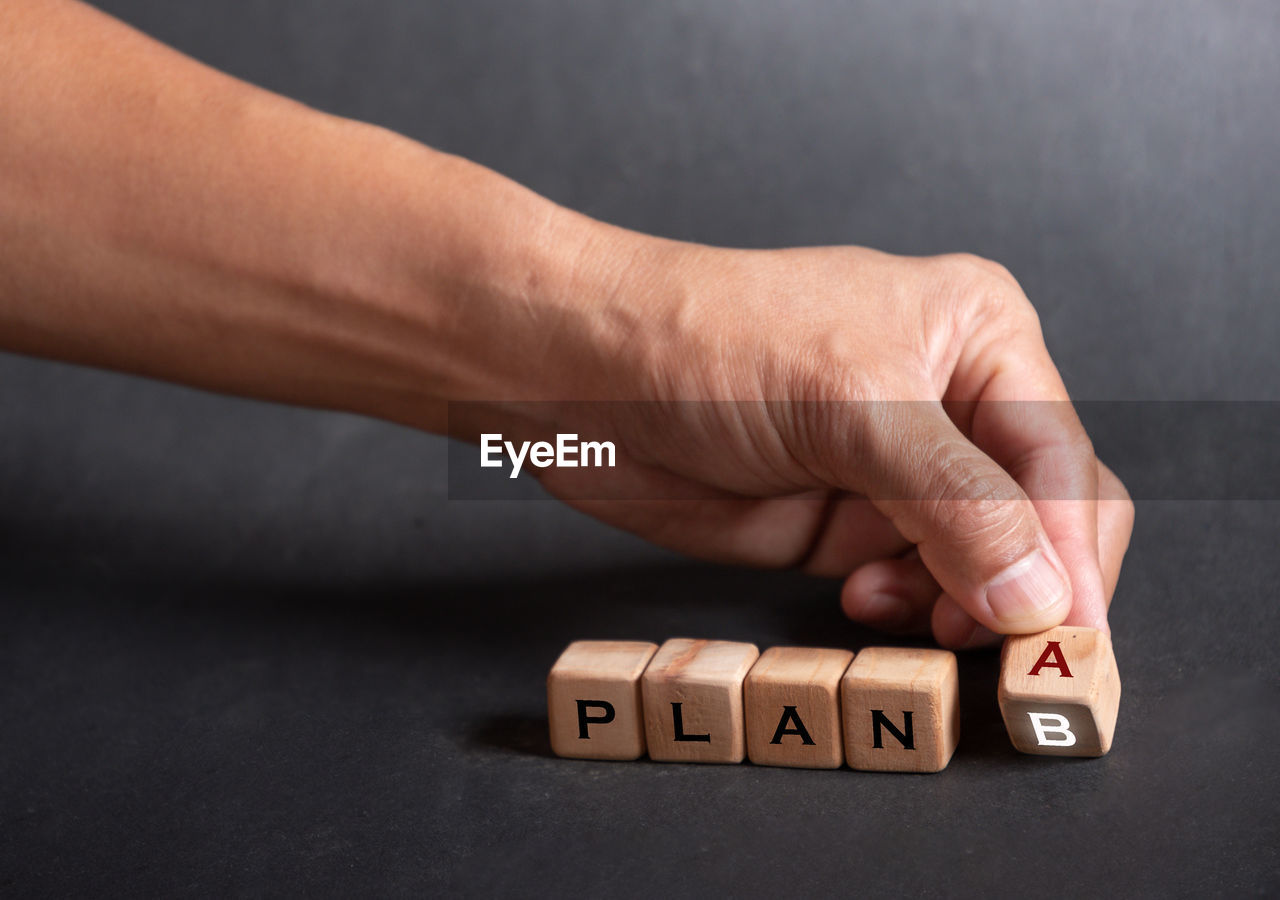 hand, indoors, close-up, studio shot, text, finger, one person, number, business, game, finance, men, adult, relaxation, leisure games