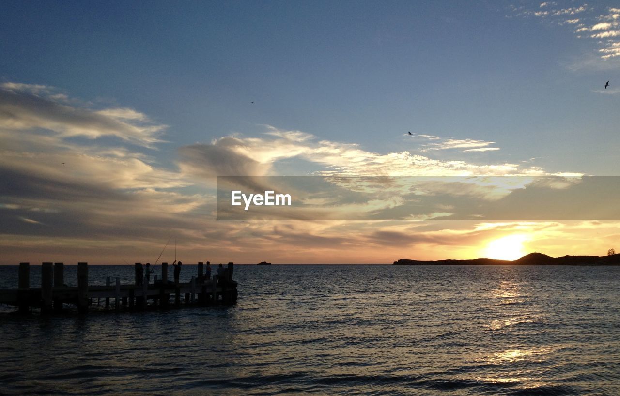 SCENIC VIEW OF SUNSET OVER SEA