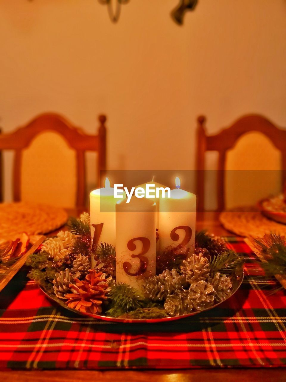 CLOSE-UP OF LIT CANDLES ON BIRTHDAY CAKE