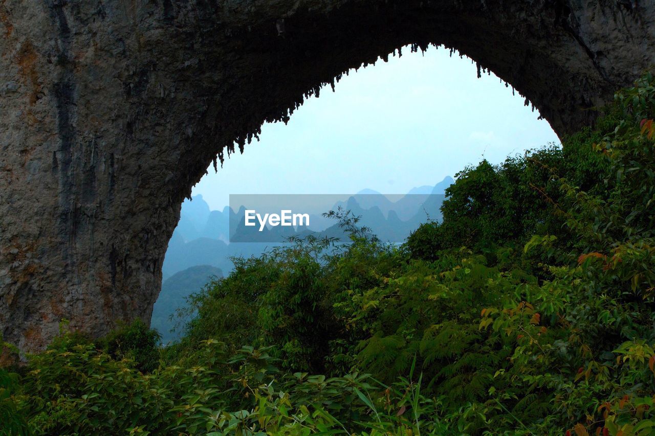 Scenic view of mountains seen through arch