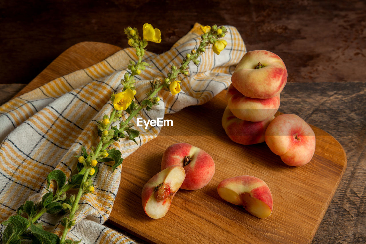 food and drink, food, healthy eating, wellbeing, freshness, fruit, plant, wood, apple, produce, no people, cutting board, indoors, still life, high angle view, table, peach, organic, apple - fruit, studio shot, rustic, vegetable, nature, slice