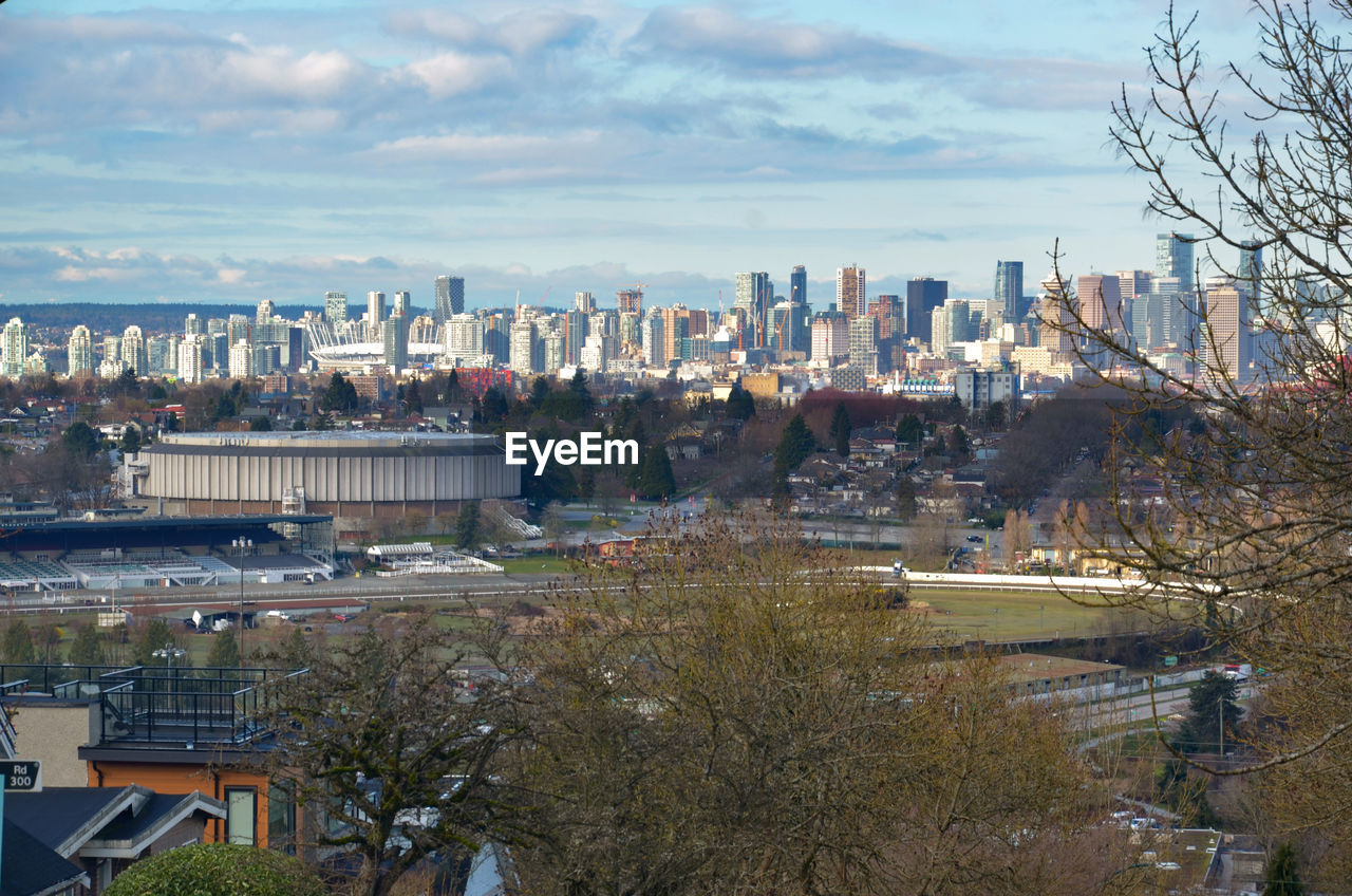 HIGH ANGLE VIEW OF TREES AND BUILDINGS IN CITY