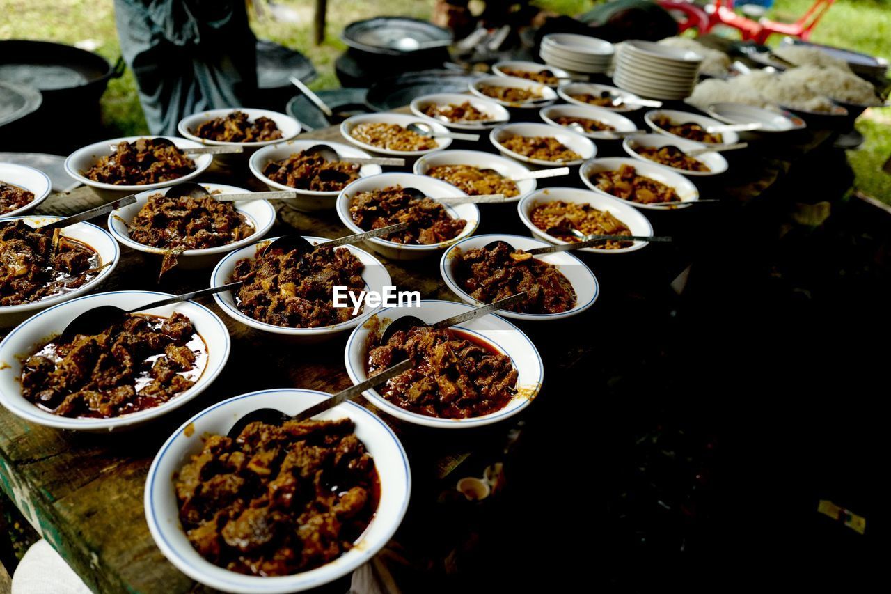 High angle view of beef curry in bowls arranged on table