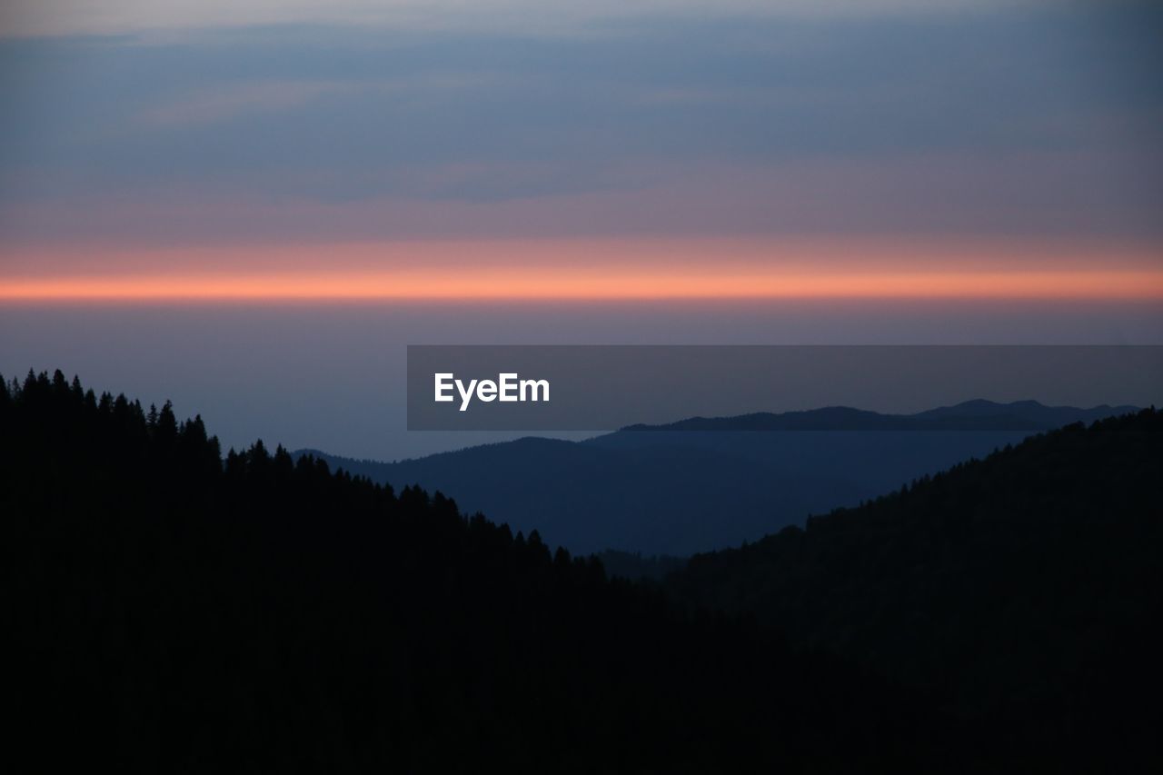 SILHOUETTE MOUNTAINS AGAINST SKY DURING SUNSET