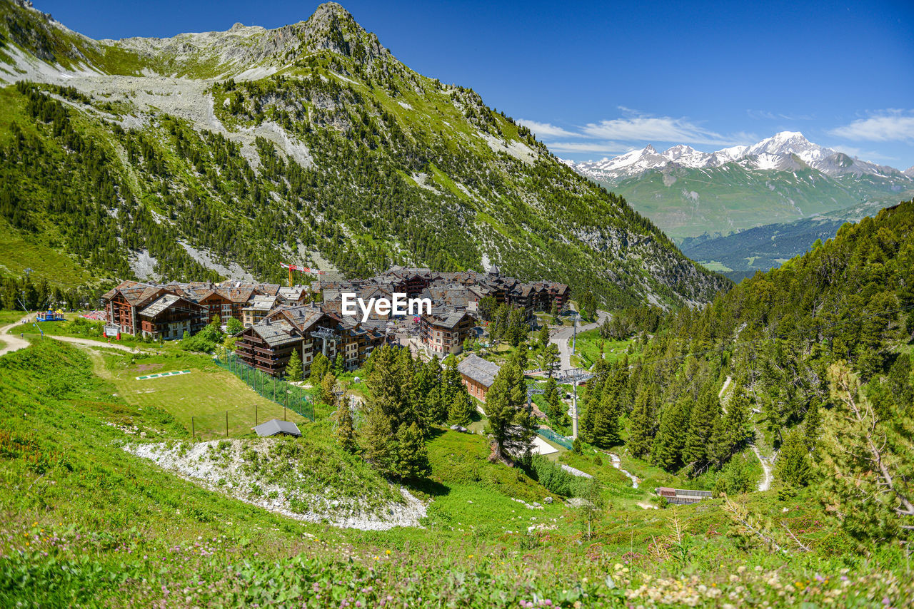 Scenic view of green mountains against sky