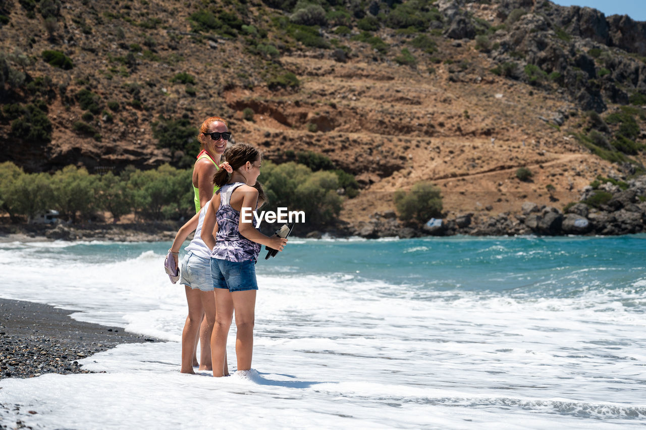 side view of woman standing at beach