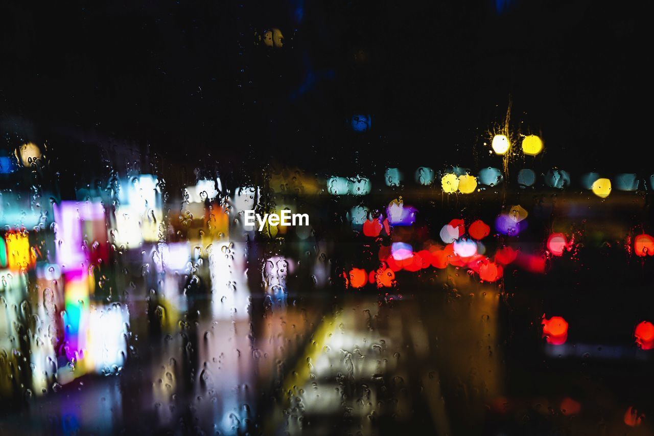 Defocused image of illuminated city at night