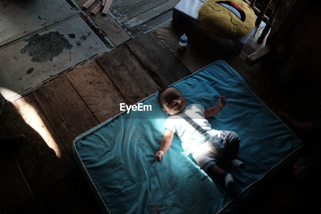 High angle view of baby boy on blanket