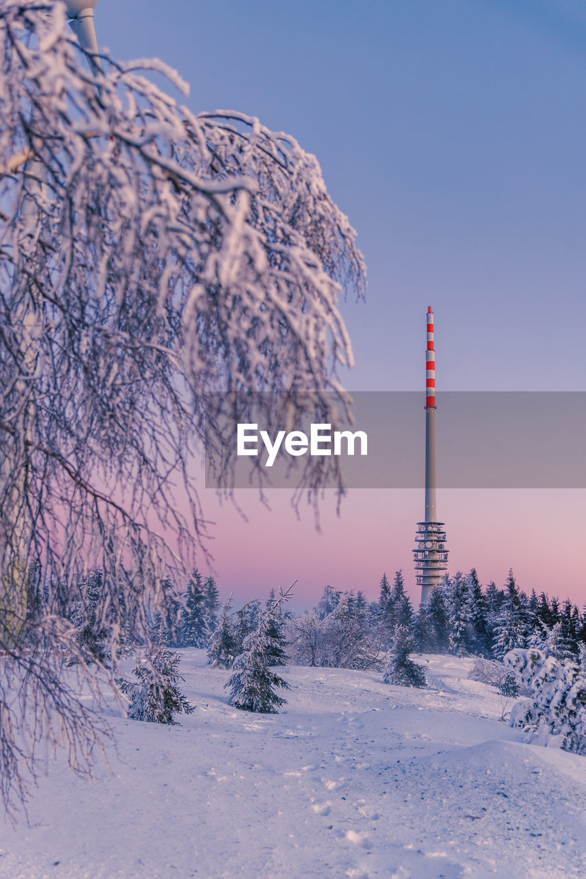 Scenic view of snow covered field against sky