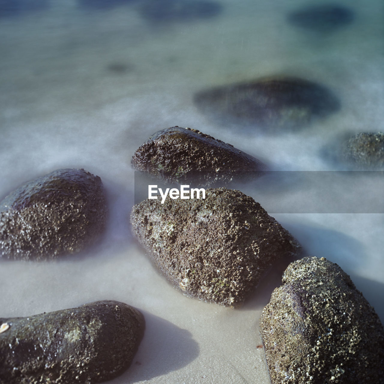 Close-up of rocks on shore against sky