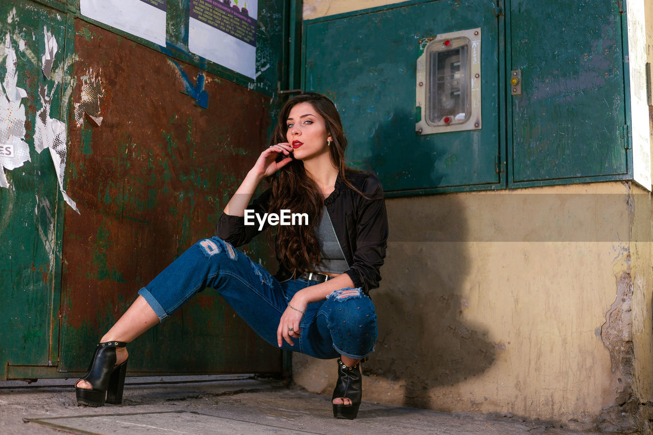 Beautiful woman posing on street photoshoot. young woman wearing casual clothing.