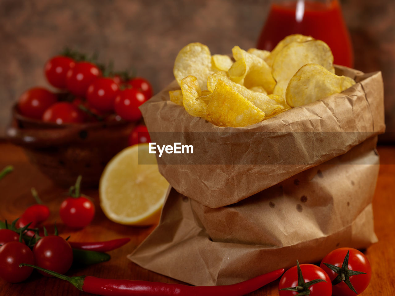 Close-up of potato chips with cherry tomatoes on table