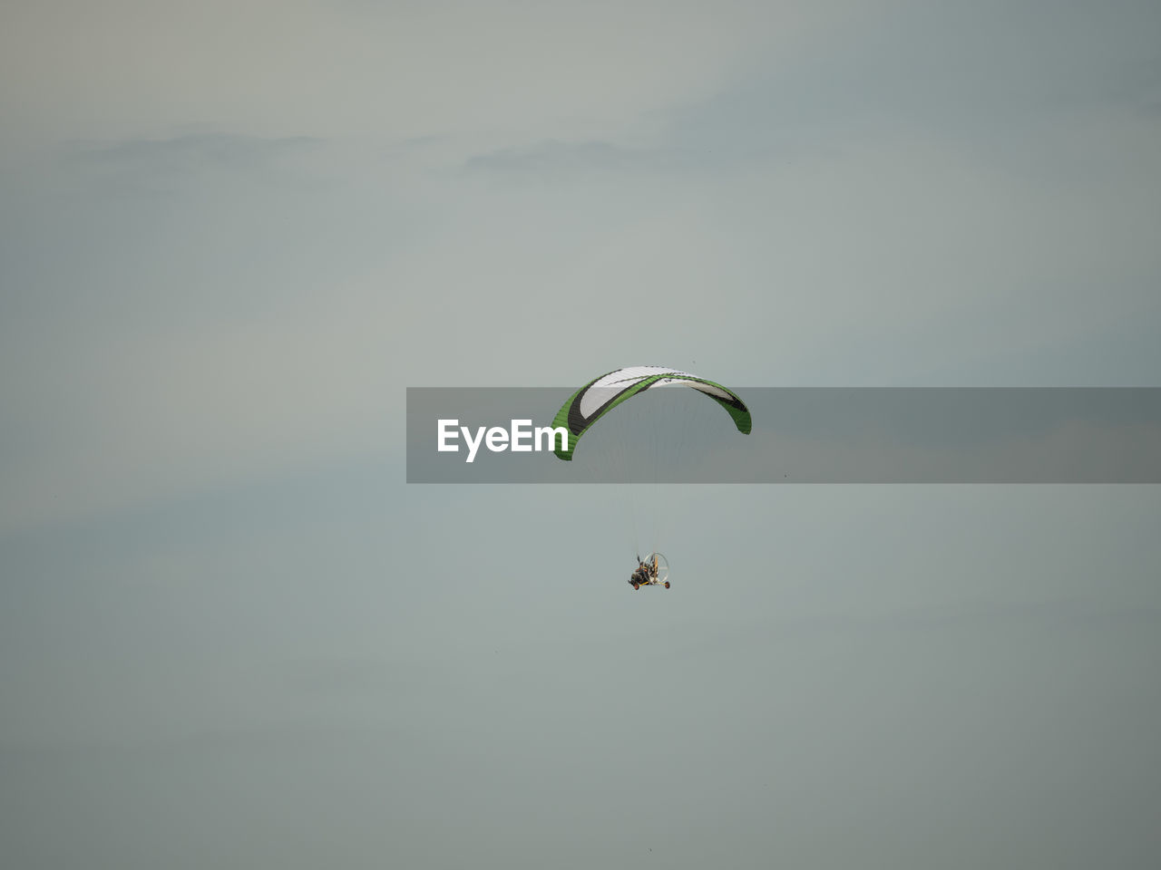 LOW ANGLE VIEW OF PERSON PARAGLIDING OVER THE SKY