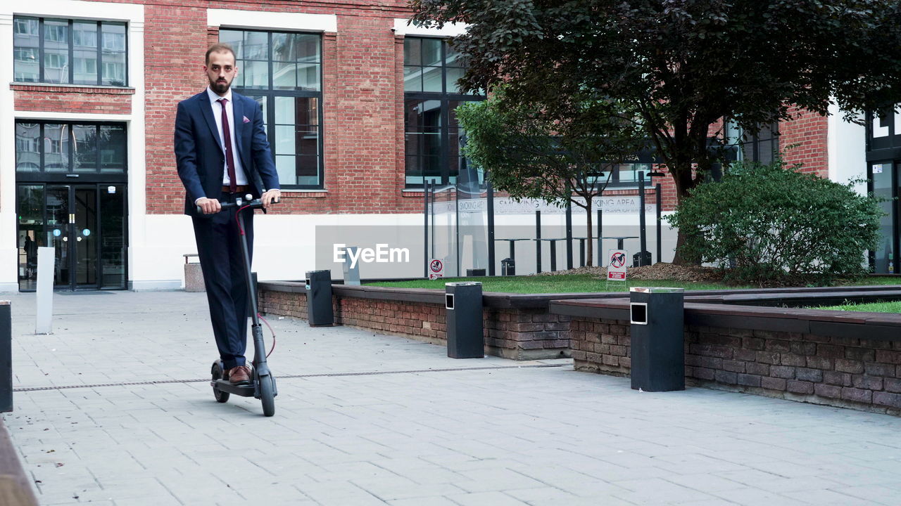 rear view of man standing on footpath