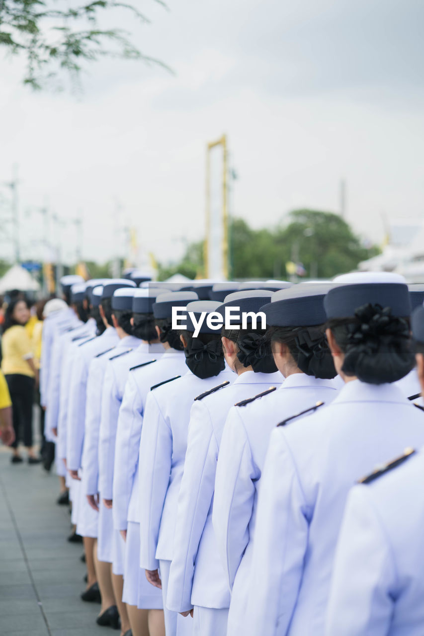 Rear view of soldiers on footpath during parade