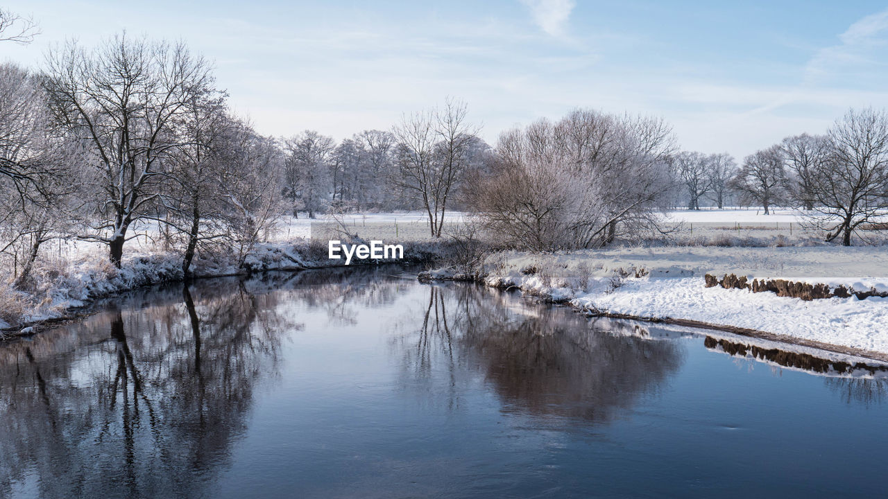 SCENIC VIEW OF FROZEN LAKE AGAINST SKY