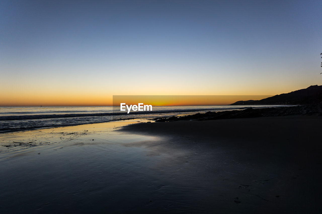 Scenic view of sea at sunset