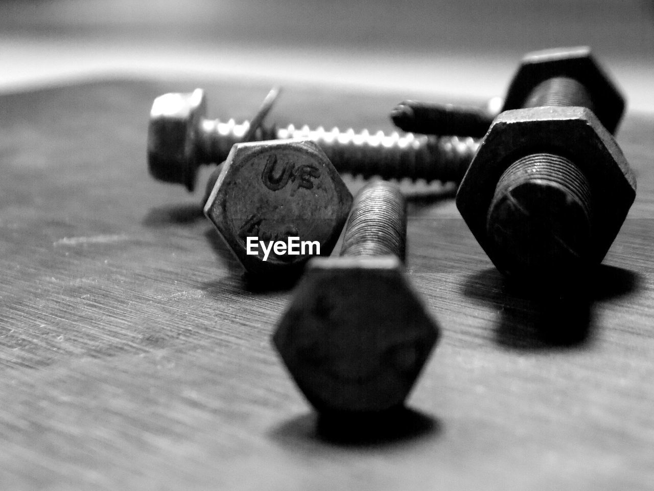 Close-up of screws and bolts on table