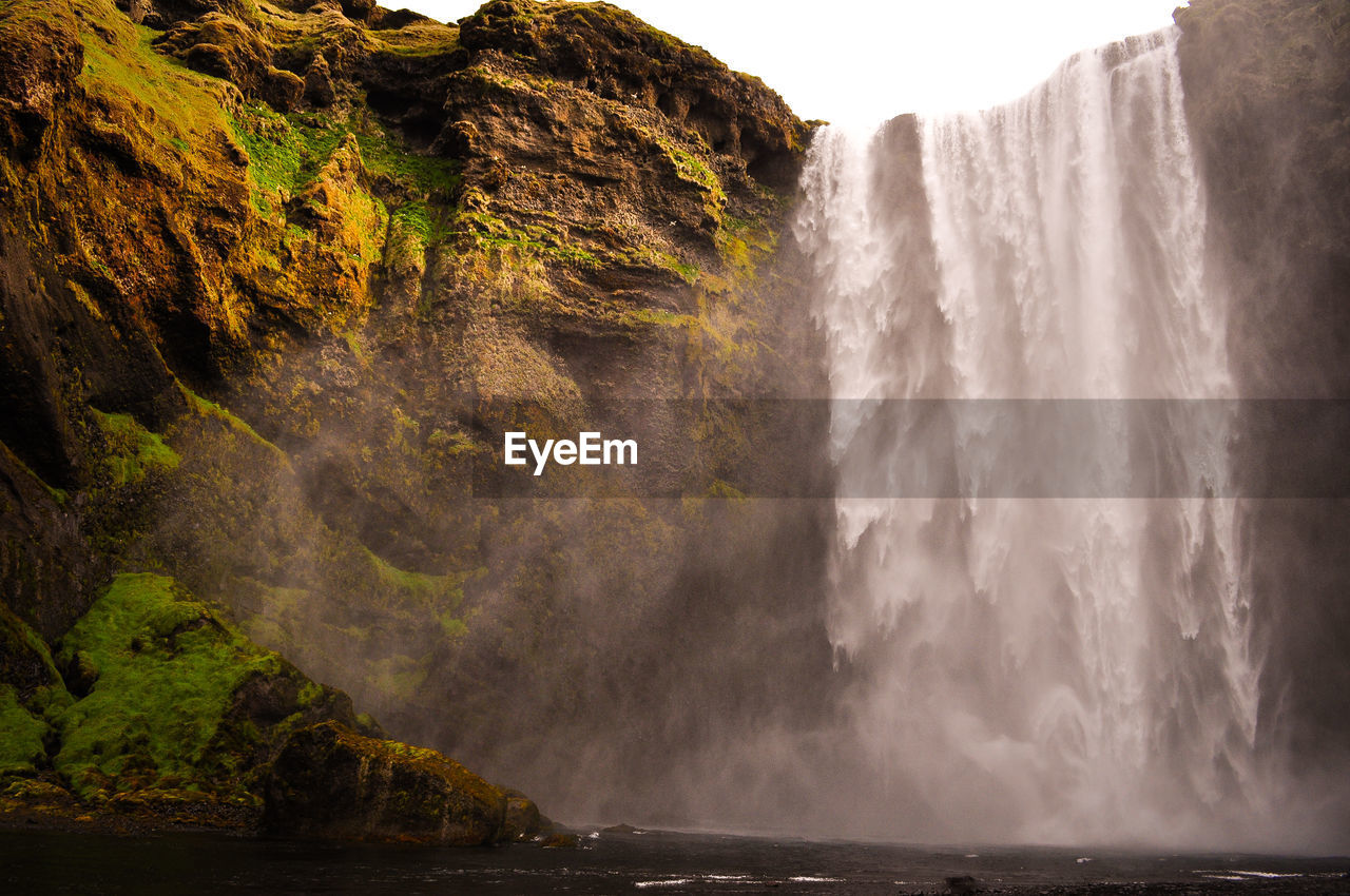 scenic view of waterfall against sky