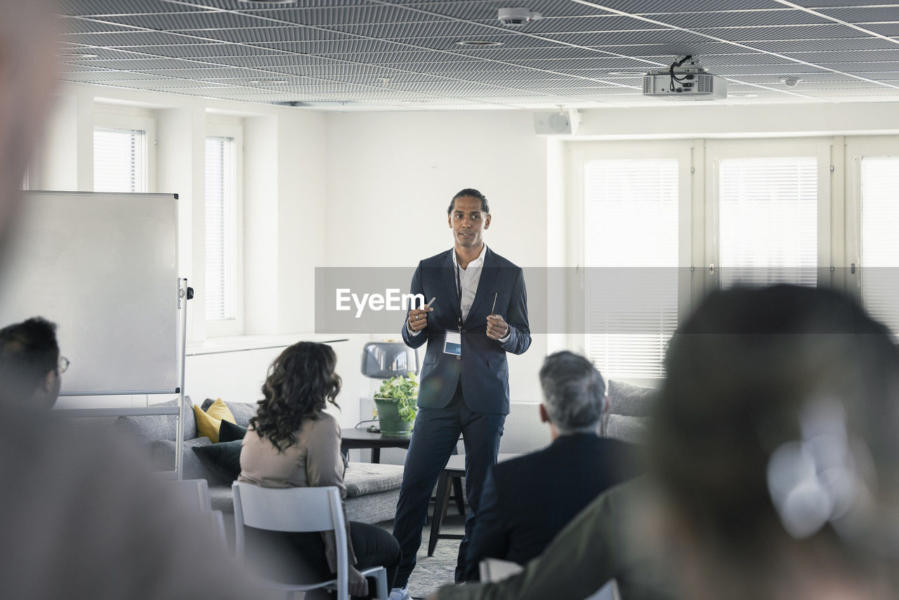 Group of business people attending presentation during conference