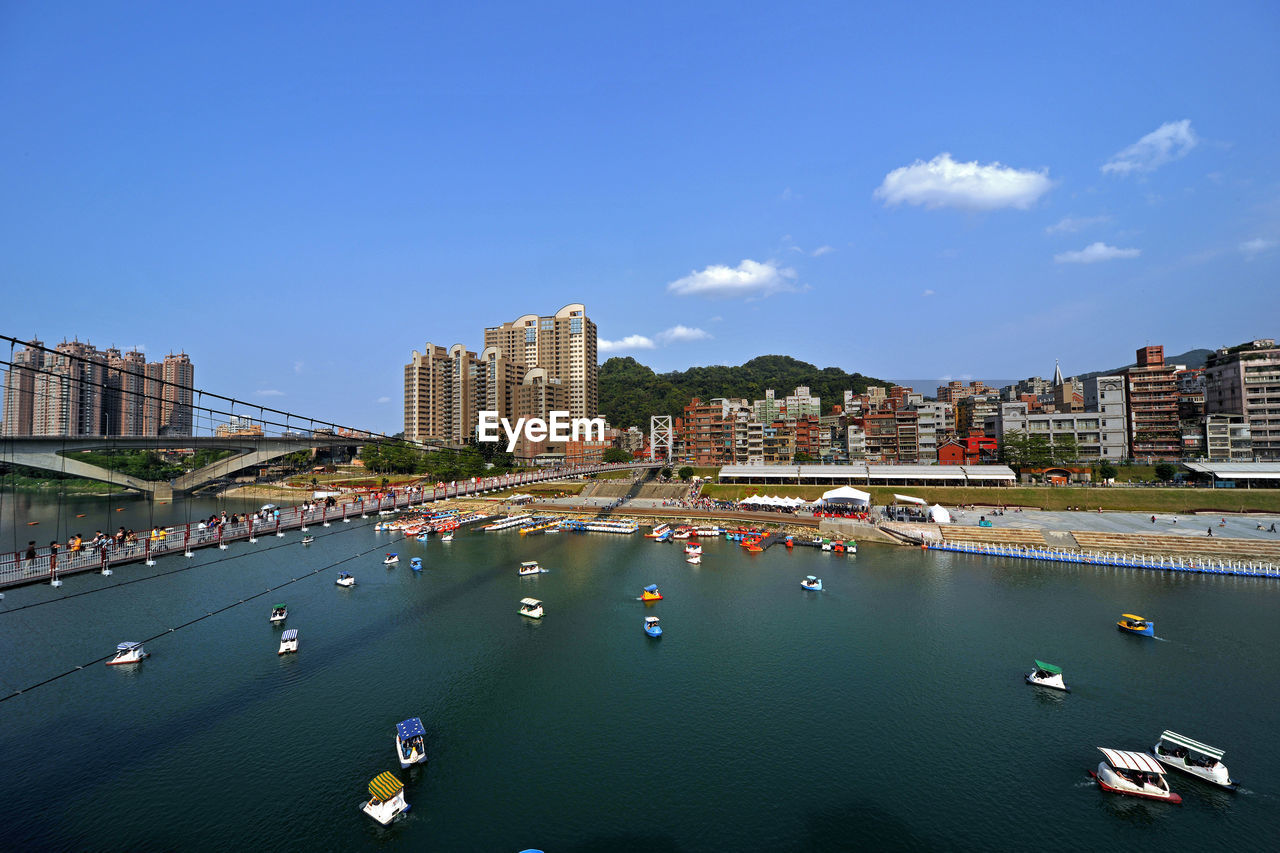 Aerial view of cityscape against blue sky