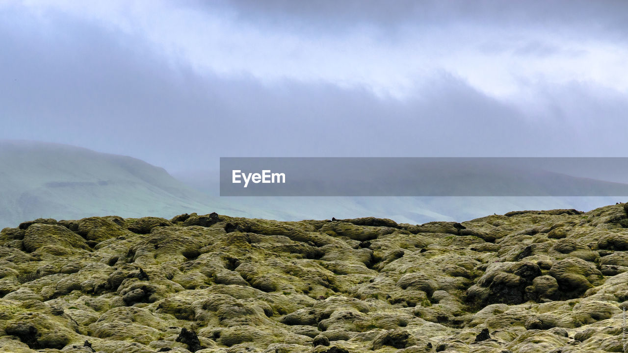 Mountains against cloudy sky