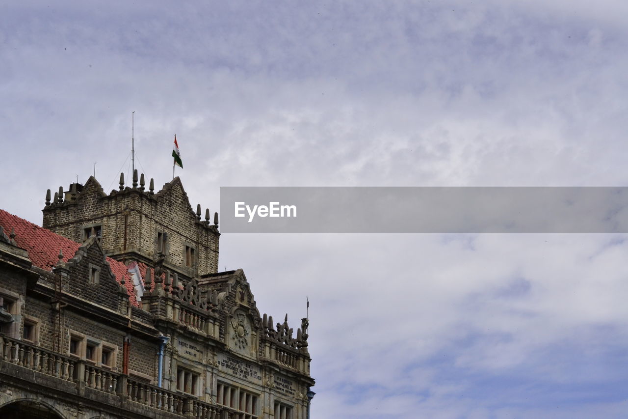 High section of building against cloudy sky