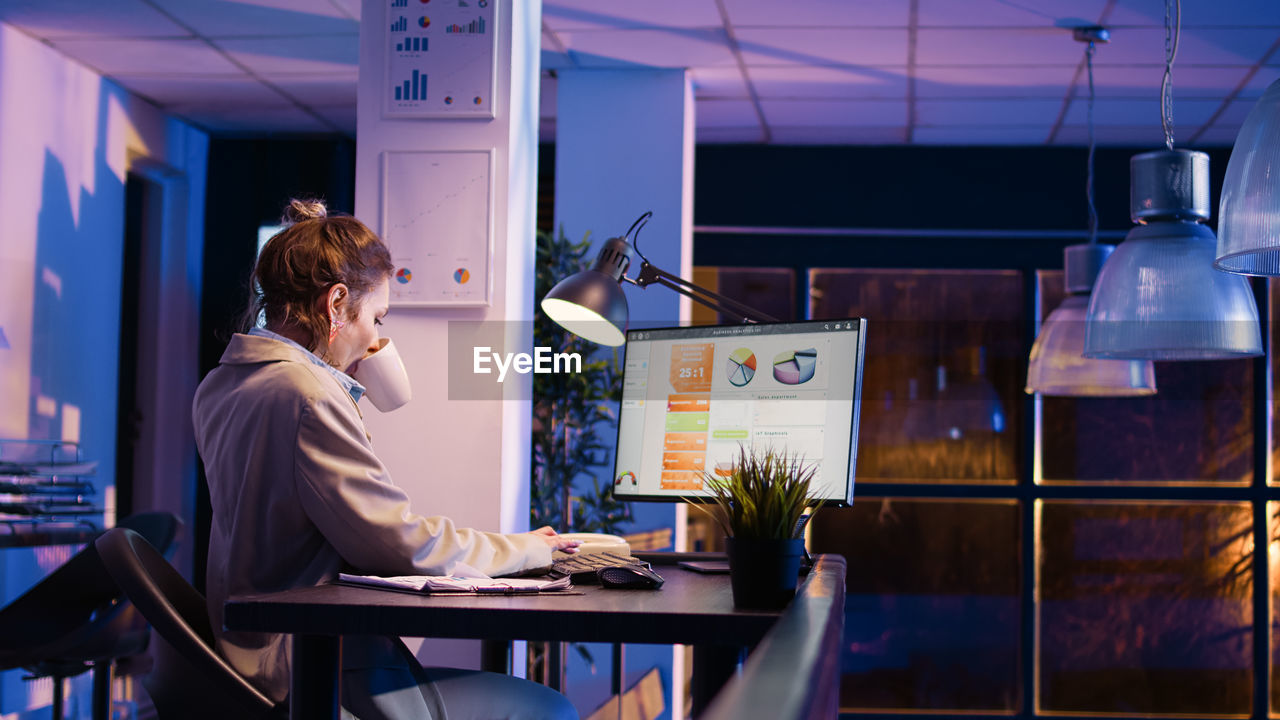 side view of business colleagues working on table