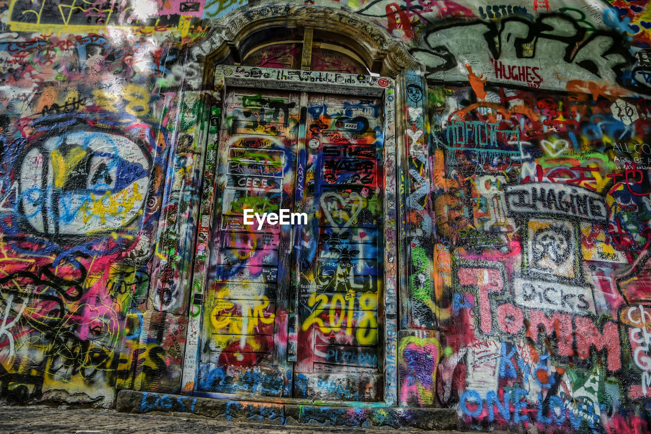 GRAFFITI ON WALL OF MULTI COLORED TEXT ON WALLS AGAINST BRICK SKY