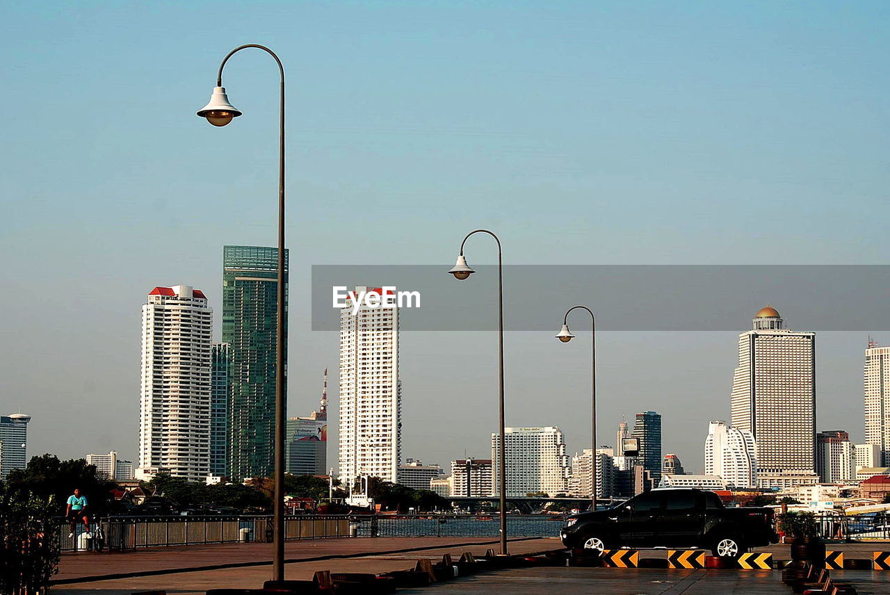 STREET AND MODERN BUILDINGS IN CITY AGAINST SKY