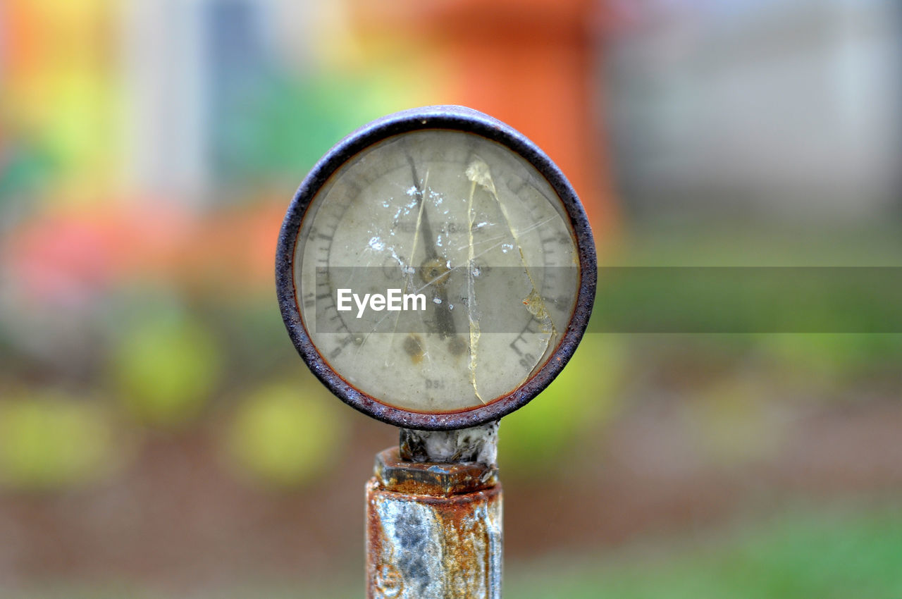 Close-up of damaged gauge against blurred background