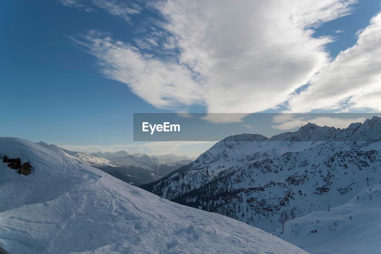 Snow covered mountain with sky in background