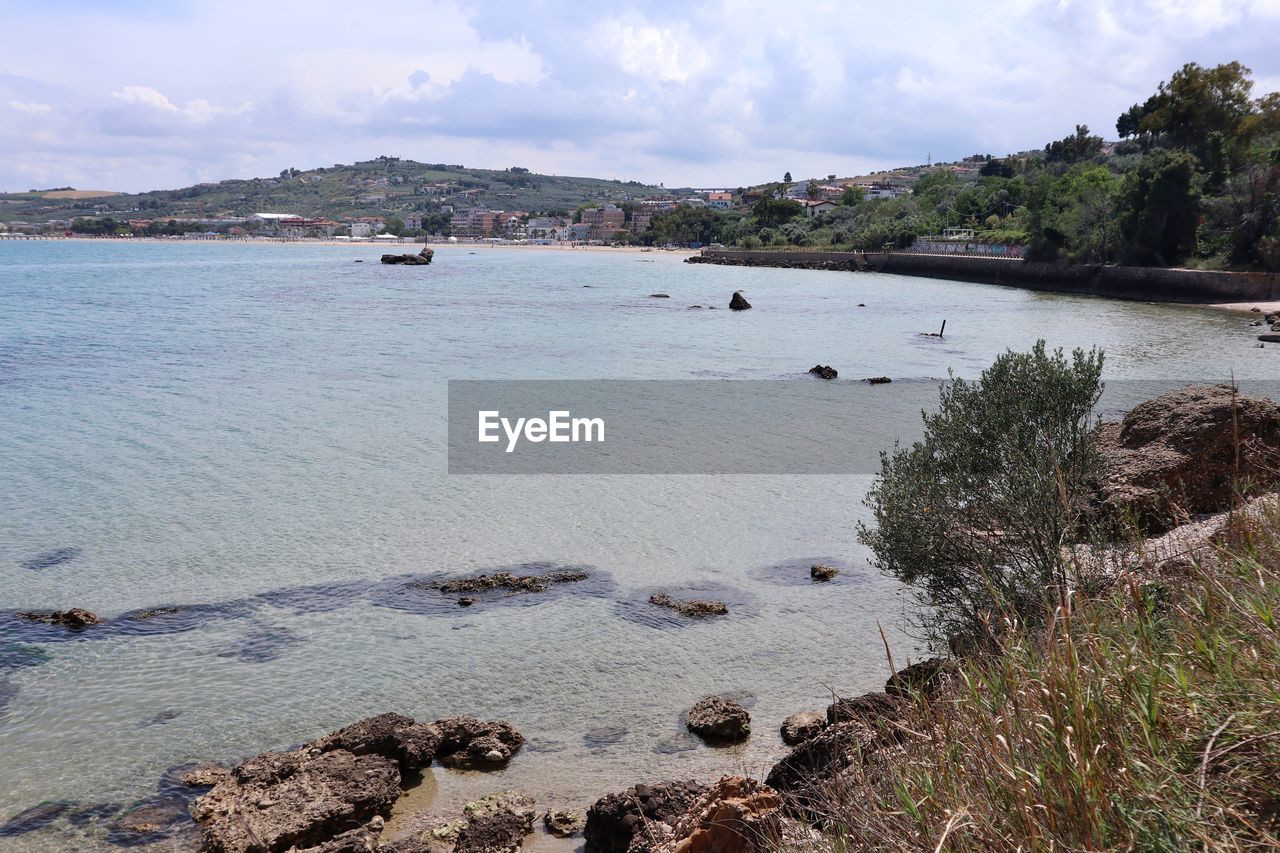 water, sea, shore, land, sky, beach, nature, coast, scenics - nature, cloud, body of water, travel destinations, environment, beauty in nature, tranquility, travel, coastline, landscape, no people, plant, day, tourism, tranquil scene, outdoors, nautical vessel, rock, architecture, reservoir, cove, transportation, tree, island, trip, bay, vacation, holiday, sand, animal wildlife, non-urban scene, idyllic, animal, bay of water