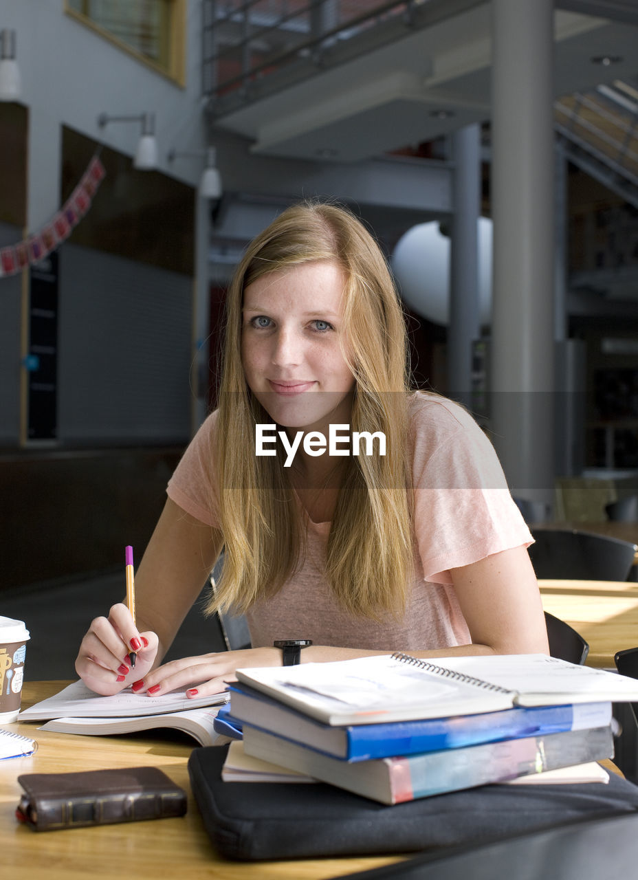 Portrait of university student sitting in cafe