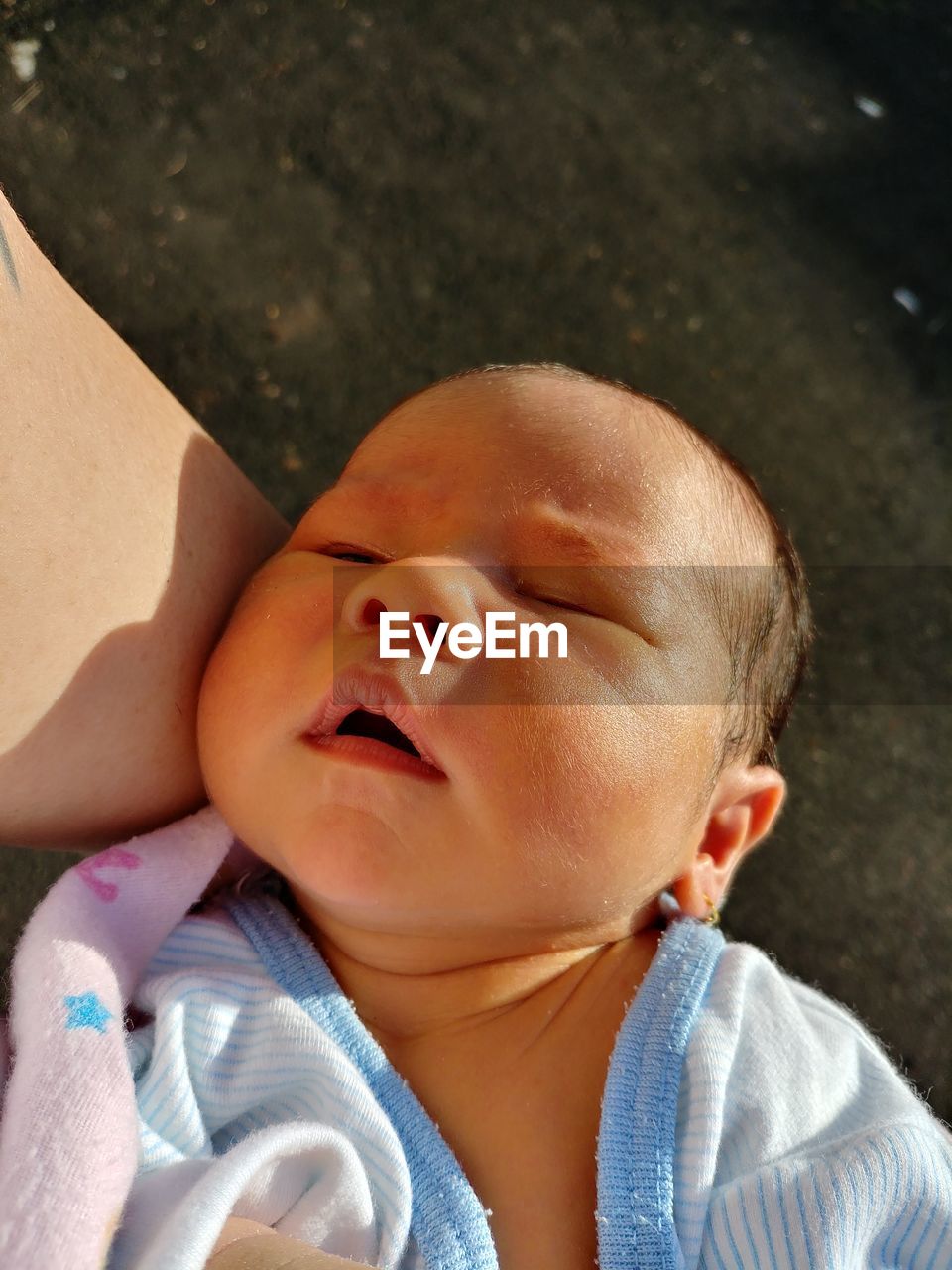 Close-up of cute baby sleeping outdoors