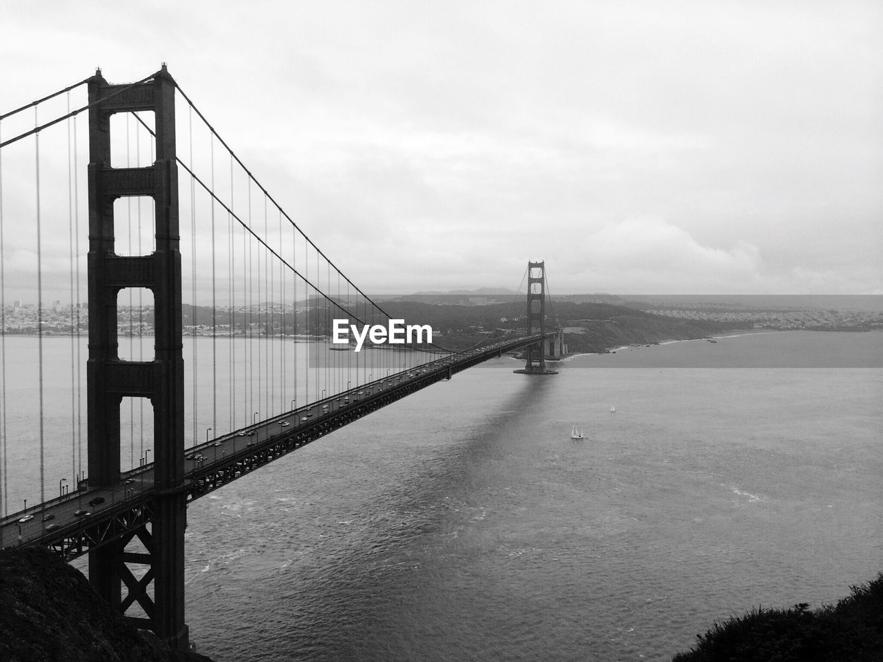 View of suspension bridge against cloudy sky