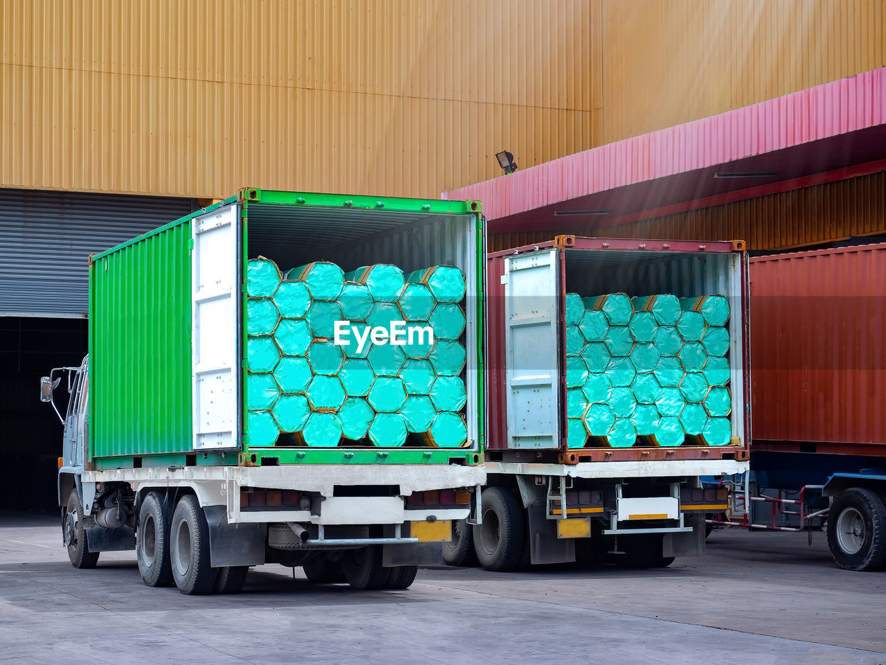 Stuffing bundle of steel pipe in containers on trucks. operation warehous concept.