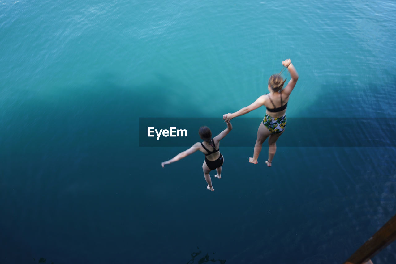 WOMAN JUMPING IN SEA